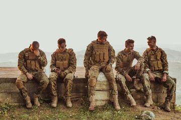 Soldiers squad relaxing after battle having a break on training