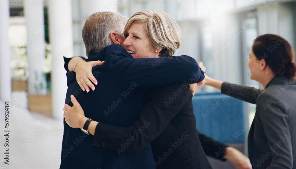 Poster congratulations you did it. cropped shot of two mature businesspeople hugging each other while in th