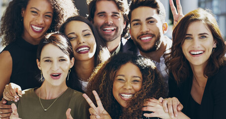 Were a peaceful enterprise. Cropped shot of a group of businesspeople giving the peace sign while standing in their office.