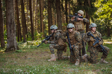 Fototapeta premium Soldier fighters standing together with guns. Group portrait of US army elite members, private military company servicemen, anti terrorist squad