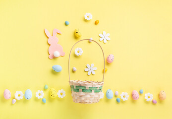 Easter Basket, Pink Felt Bunny, Sweet Easter Eggs, daisy flowers on Yellow backgroundund. und