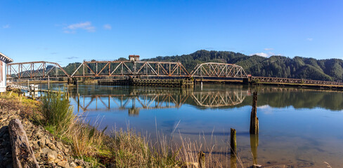 Beautiful panoramic view at the Railroad bridge over Siuslaw river in Oregon