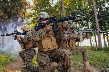 Fototapeta premium Soldier fighters standing together with guns. Group portrait of US army elite members, private military company servicemen, anti terrorist squad