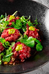 Raw beef meat tartar in plate