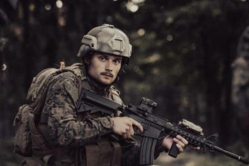 A modern warfare soldier on war duty in dense and dangerous forest areas. Dangerous military rescue operations