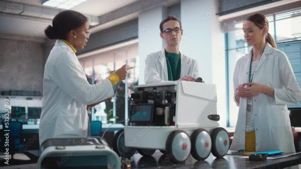 Poster Diverse Team of Industrial Specialists Working on Remotely Controlled Robot, Using a Laptop. Young Male and Female Engineers Discussing an Autonomous AI Delivery Assistant Prototype, Brainstorming