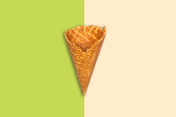 Ice cream cone on a pistachio beige background. Summer holiday concept. Food.