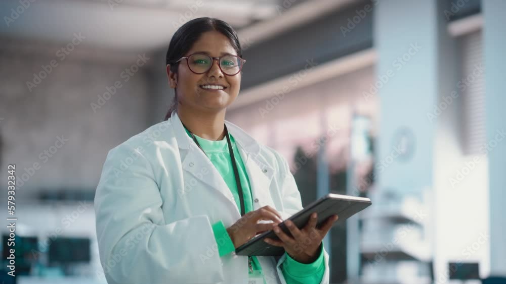 Leinwandbilder portrait of young black female specialist in a lab coat smiling and using laptop computer. professio