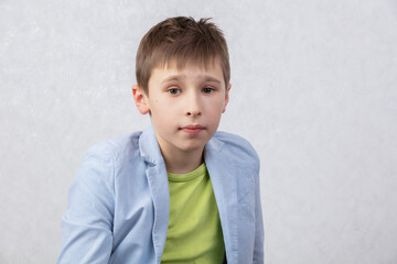 Portrait of a boy of middle school age in a jacket. The child is ten years old.