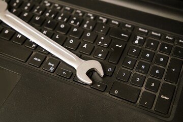 wrench on a keyboard - IT-support maintenance or help with computer problems