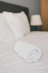 Obraz na płótnie Canvas Bed and white linens in a hotel room.