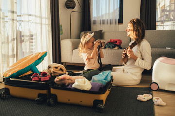 Mother and daughter packing before the trip.