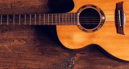 Top view of classical guitar on old wooden background.dark tone