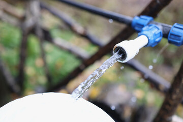 Polyethylene water pipes and clean water jet close-up.