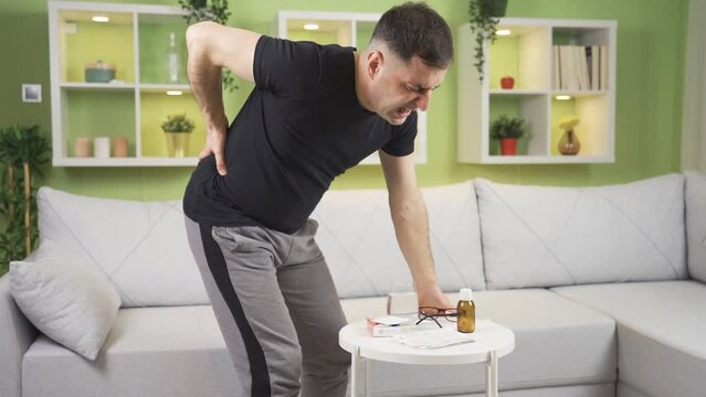 Man with herniated disc is suffering, suffering from pain.
Man with herniated disc lifting heavy objects is in pain and has pain in his lower back.
