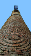 a brick tower in the form of a barrel of a weapon directed into the sky