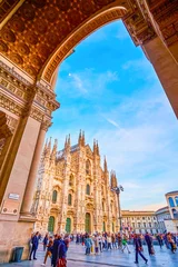 Gordijnen The view on Duomo di Milano throught the main entrance portal of Galleria Vittorio Emanuele II, Milan, Italy © efesenko