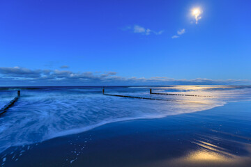 Beautiful Baltic sea beach on the Hel Peninsula with the full moon. Poland