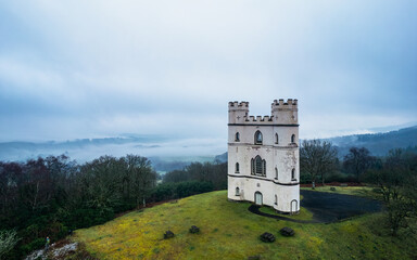 Misty morning over Haldon Belvedere from a drone, Lawrence Castle, Higher Ashton, Exeter, Devon,...