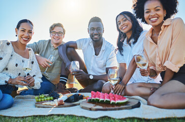 Wine, fruit or friends at picnic to relax or bond on summer holiday vacation at countryside on grass field. Portrait, trust or happy people eating fruits with drinks to celebrate a reunion in nature