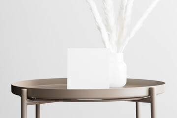 Square invitation card mockup with a pampas decoration on the beige table. 5x7 ratio, similar to A6, A5.