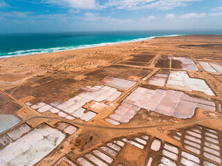 Aerial photos of Salines in Santa Maria, Sal Island in Cabo Verde showcase stunning salt flats, colorful patterns created by salt ponds, machinery used for salt harvesting