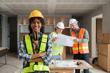 portrait female engineer project manager with construction gear and project blueprint Architecture team building plans