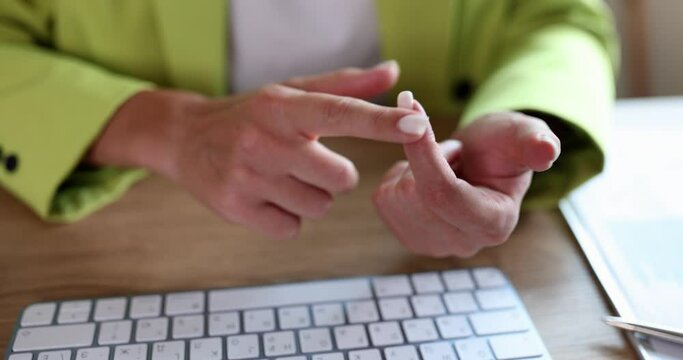 Woman manager or accountant counts numbers in document and summarizes results on fingers