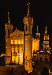 Panoramic aerial shot at night time of illuminated Basilica Notre Dame de Fourviere 