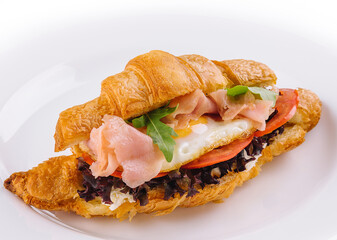breakfast with croissant sandwiches with fried egg and salmon