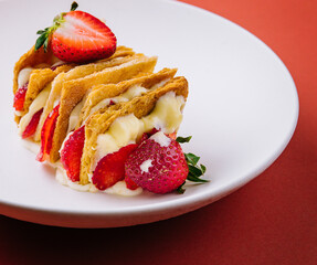 Strawberries and cream mille feuille dessert on plate