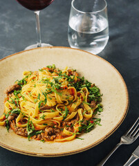 egg pasta tagliatelle with bolognese sauce made from meat and tomato sauce