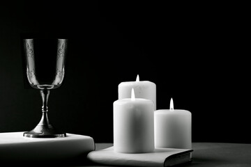 Fantastic metal chalice with candles about book, text space, photograph in Black and White