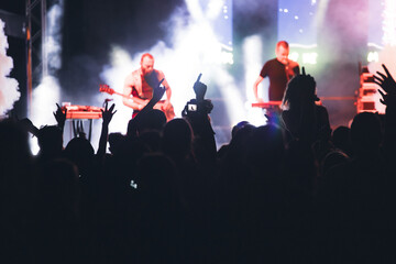 Crowd at concert and blurred stage lights.