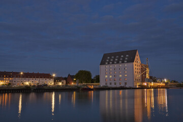 Fototapeta na wymiar House illuminated at sunset in the harbor of Munster, Germany