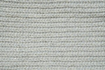 light grey knit sweater pattern with gold tinsel. Cozy nordic background. Ornate wool texture