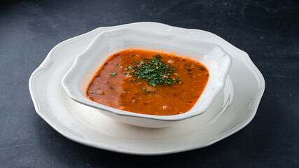 Hot vegetable soup with potatoes, carrots, onions, tomatoes and herbs.