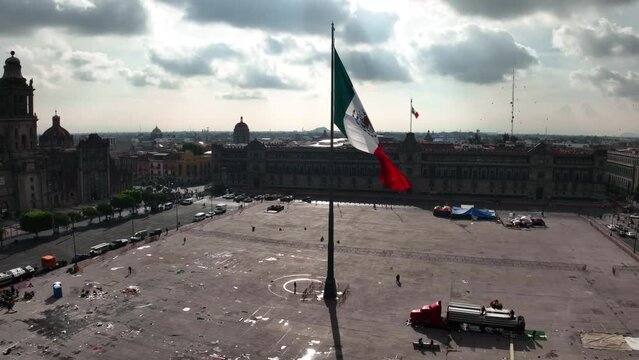 Large Mexican flag at the Zocalo Square, quiet day in sunny Mexico city - Aerial view
