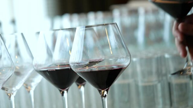 Gentle Hand Pick Up Transperent Glass Of Red Wine Out Of Other Glasses