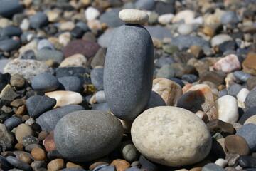 Fototapeta na wymiar Pebbles on a rocky beach on a sunny day.
