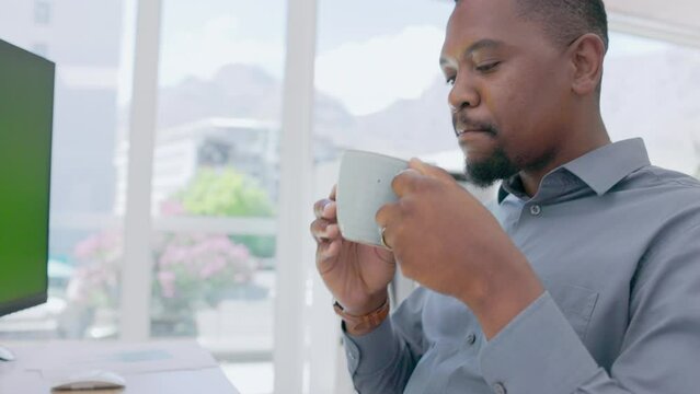 Black man drinking coffee in office, computer and pc with green screen in company. Manager, desktop and working online with cup of tea for productivity, energy and business planning in startup agency