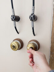 Hand on metal door holder