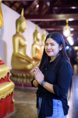 Portrait asian woman tourist Pay respect hand with faith to Buddha statue in temple thailand belief in Buddhism