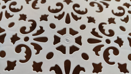 Abstract pattern on white plastic. Background. Texture. Abstract drawing for background and texture. Stencil for drawing with a pattern of flowers