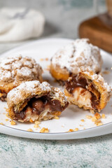 Freshly baked cream puffs. Eclair cake with cream and chocolate filling. Close up