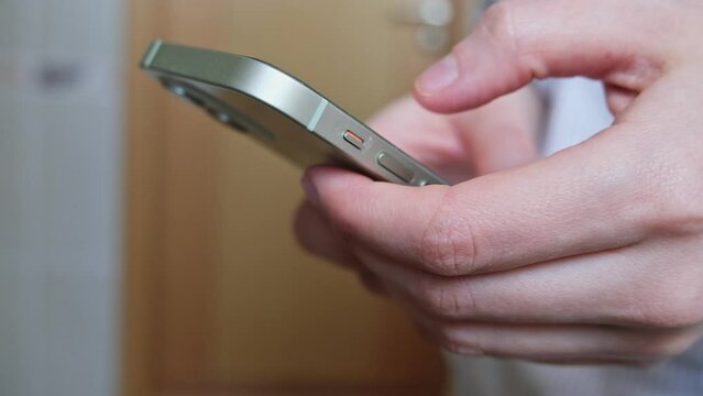 Woman using smartphone pressing finger, reading social media internet, typing text or shopping online. Mobile phone at home or work. High quality FullHD footage