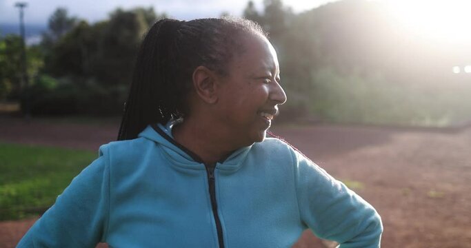 African senior woman having fun  after sport workout at city park