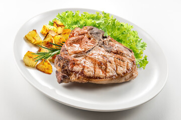 Grilled t-bone chop of pork with salad and potatoes
