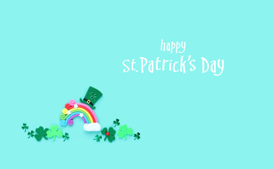 Happy St. Patrick’s Day greeting card. clover leaves, toy rainbow and leprechaun hat on abstract green background. symbol of 17 march, irish traditional holiday. flat lay. template for design
