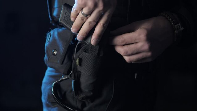 Close up of a holstered handgun on the hip of a policeman or security guard on duty